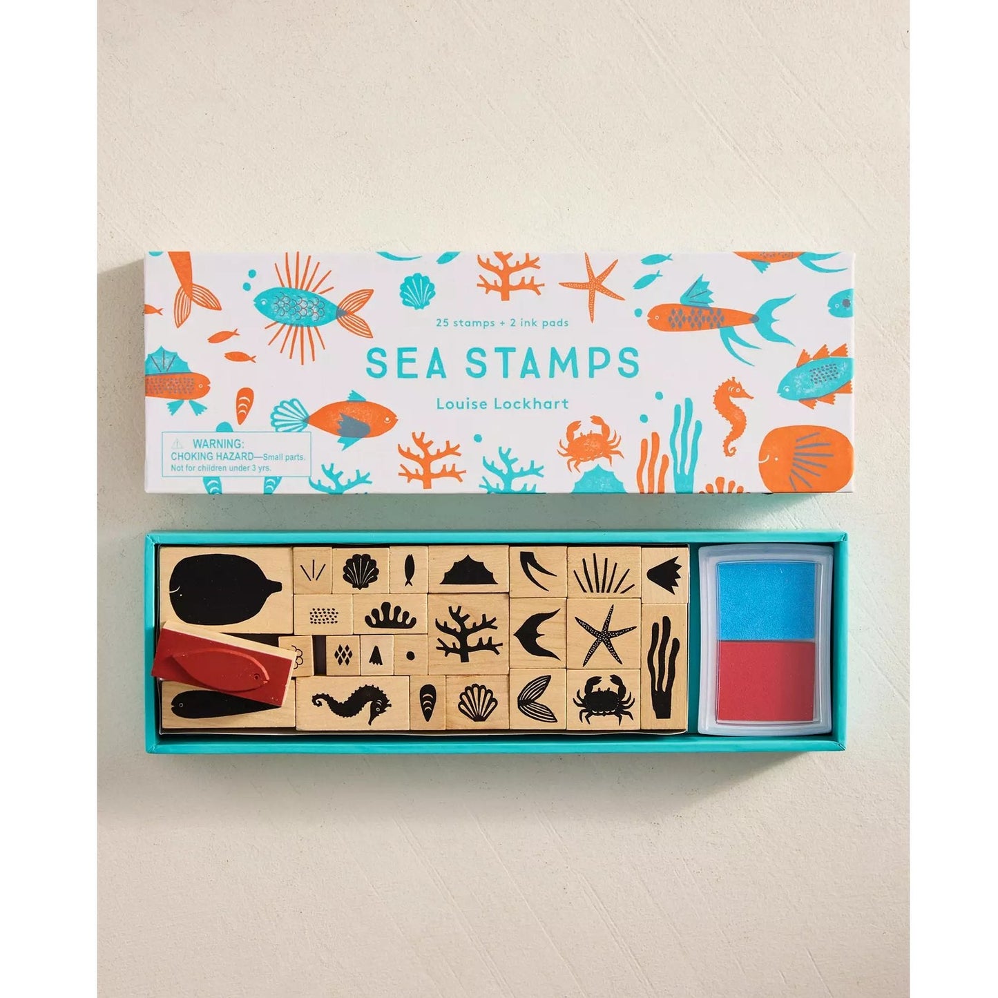 Box of sea-themed stamps with colorful packaging on a beige background