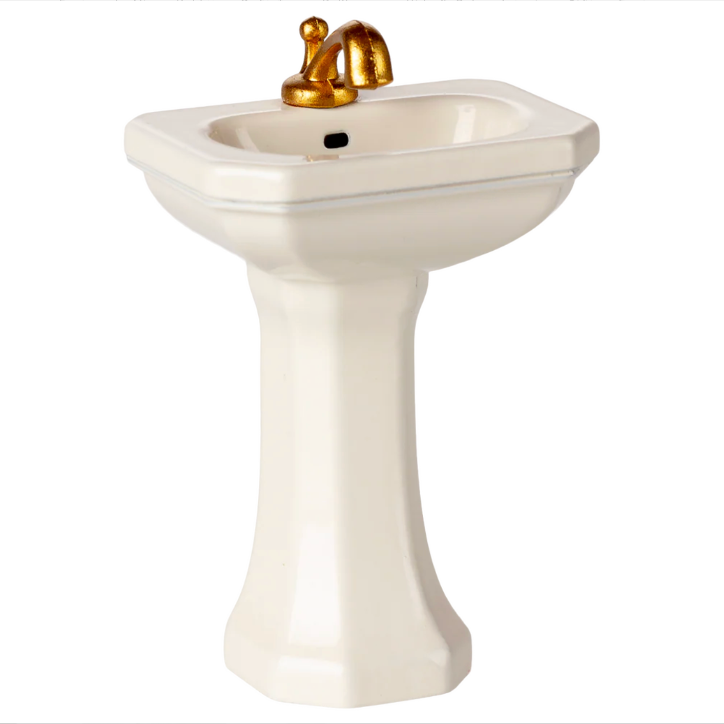 White pedestal sink with gold faucet on a white background