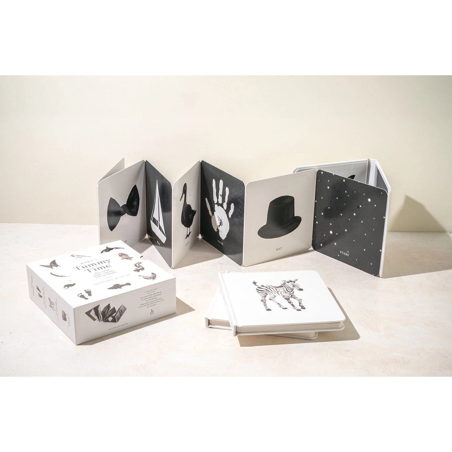 Black and white photo album with handprints on a light surface