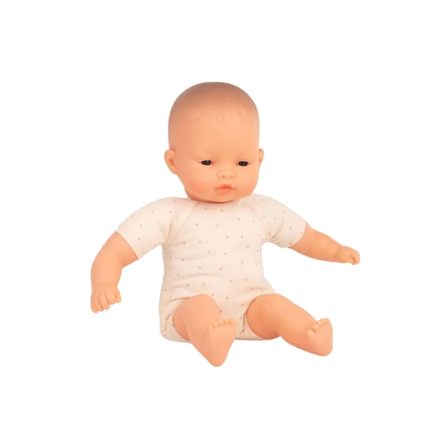 Baby doll wearing a white onesie on a white background