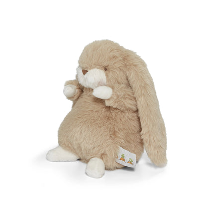 Plush toy rabbit with a white tag on a white background