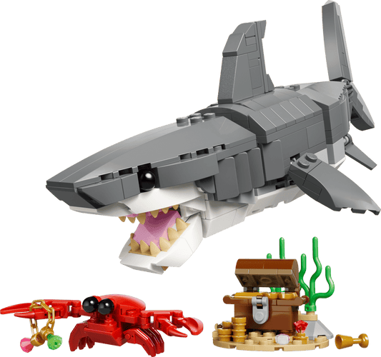 Toy shark model with a crab and treasure chest on a transparent background