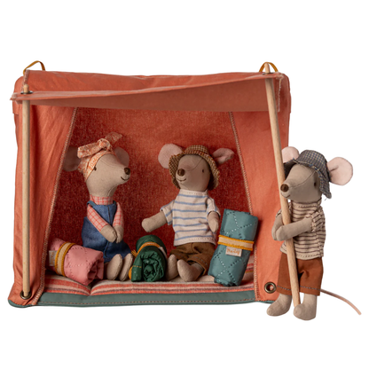 Three plush mouse toy figures dressed in vintage camping clothes, posed inside and beside a small orange canvas tent with wooden poles on a white background.