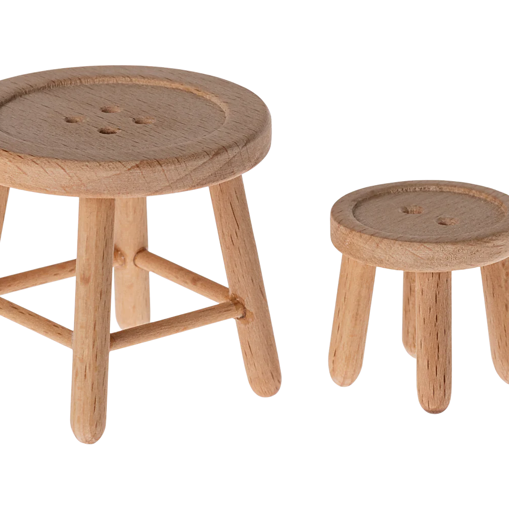 Two wooden stools with round seats on a white background