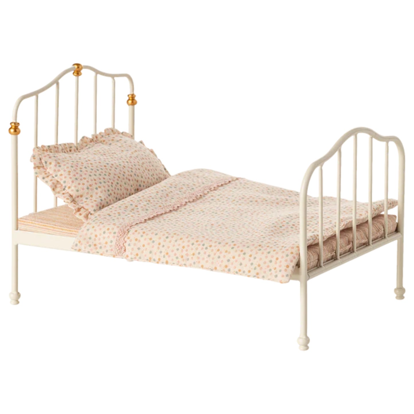Small bed with white metal frame and bedding on a white background
