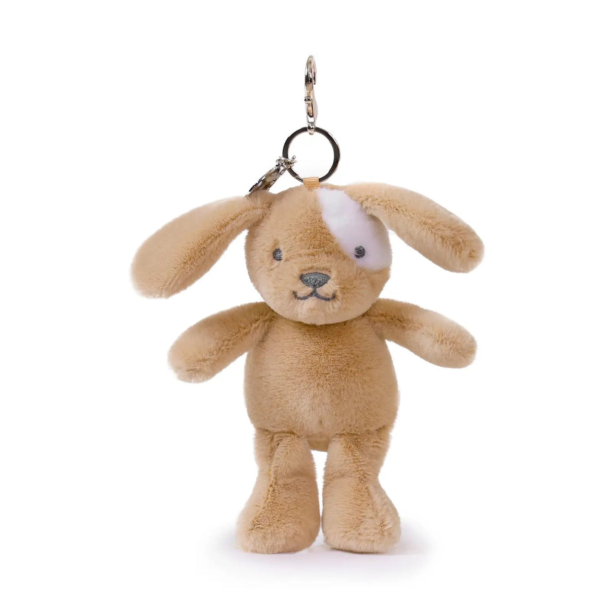 Plush dog keychain with a white patch on a white background