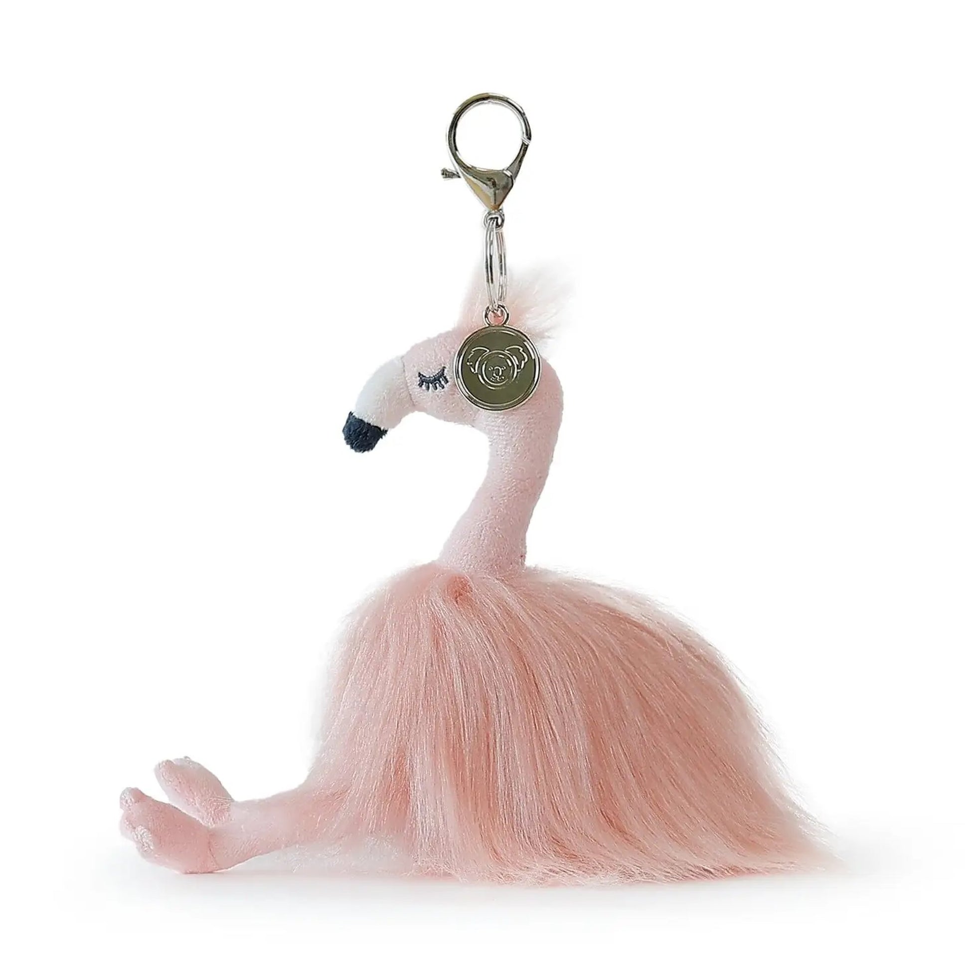 A pink plush flamingo keychain with a fluffy skirt, black beak, and a gold-tone lobster clasp with a round tag, shown on a white background.