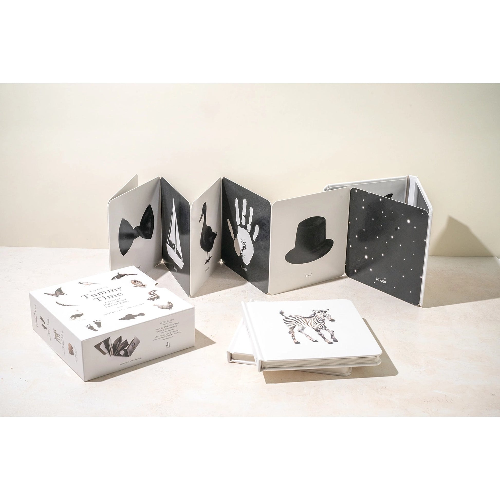 Black and white photo album with handprints on a light surface