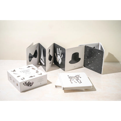 Black and white photo album with handprints on a light surface