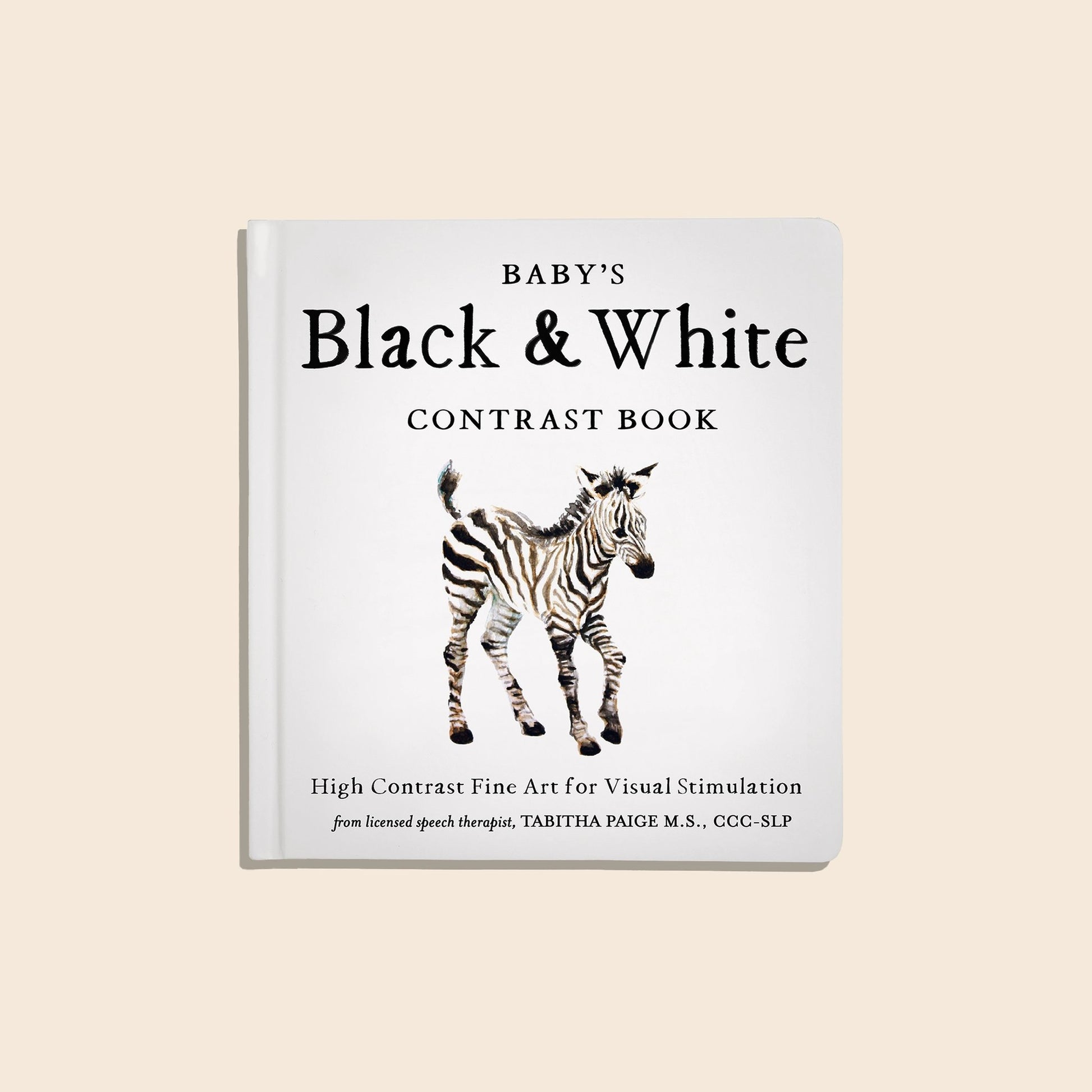 Book titled 'Baby's Black & White Contrast Book' with a zebra illustration on a beige background