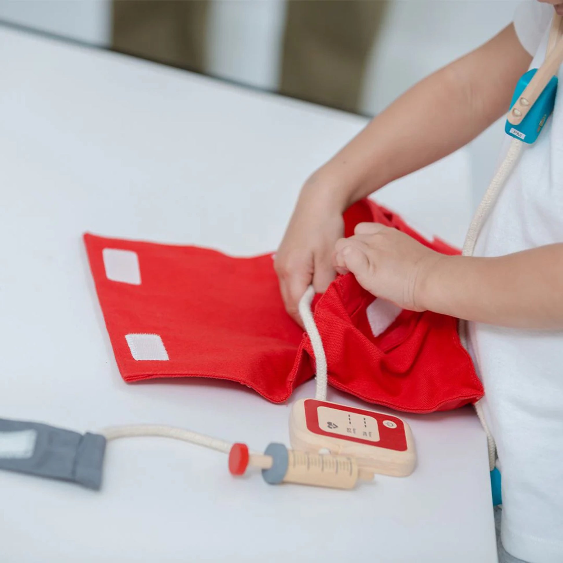 child playing with pretend doctor kit