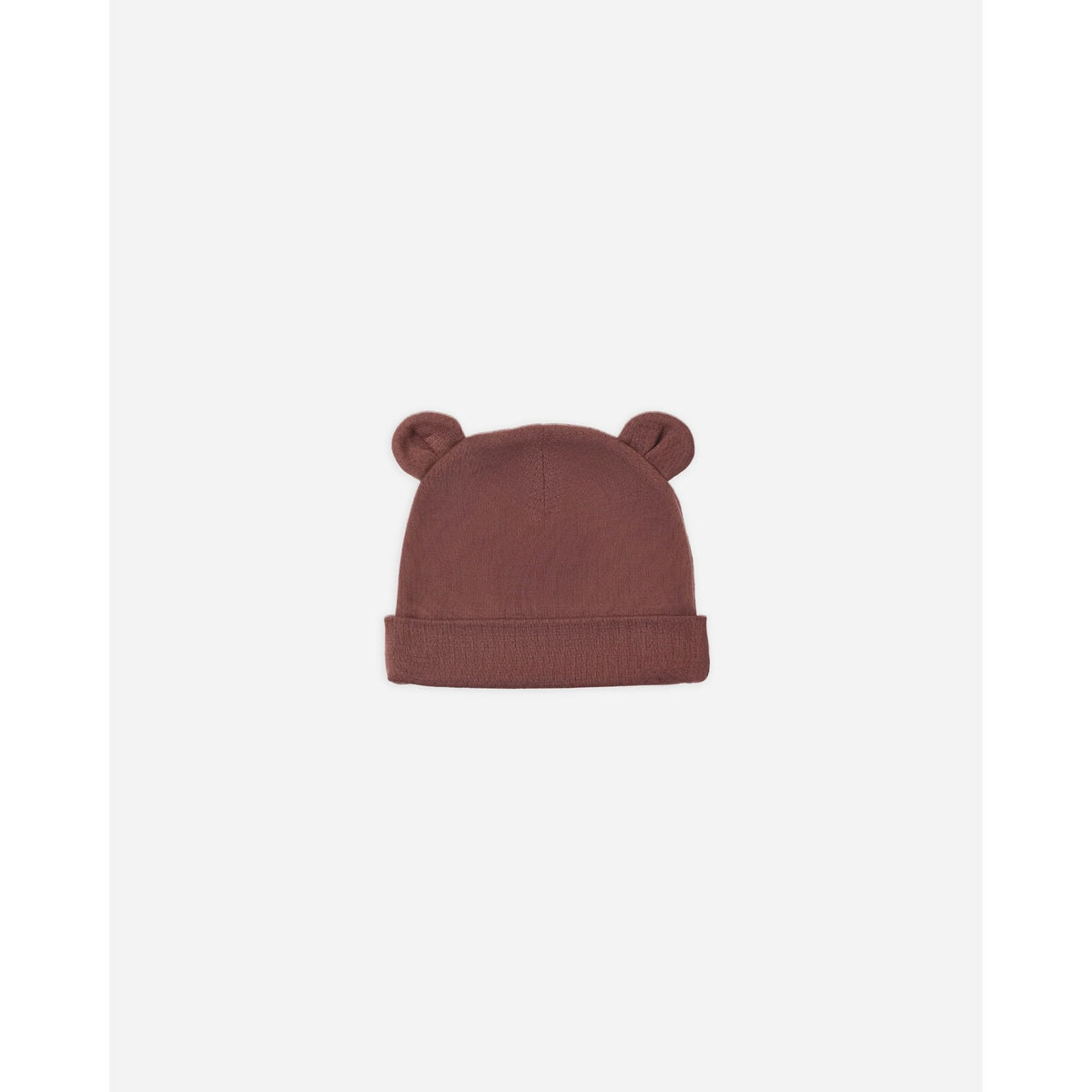 A dusty rose pink knit beanie hat with small bear ears on top, shown against a plain white background.