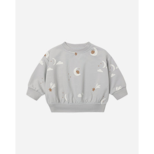 A light gray long-sleeve crewneck sweatshirt for toddlers, featuring an all-over celestial print of white clouds, crescent moons, and small brown stars.