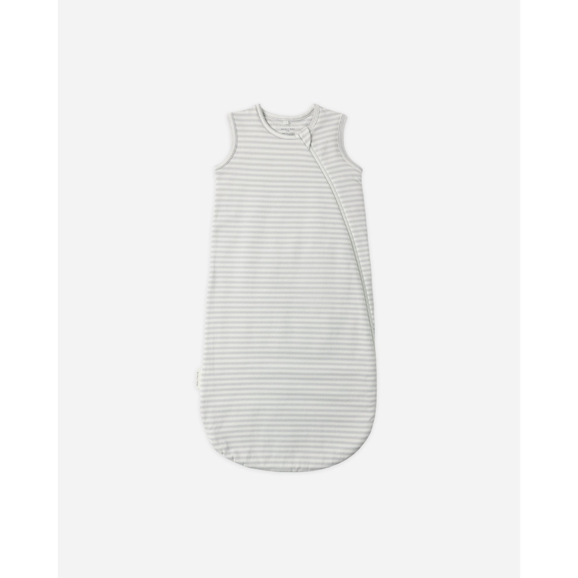 A sleeveless baby sleep sack with fine horizontal stripes in light gray and white, featuring a snap closure down the front, shown against a plain light gray background.