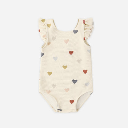 Baby swimsuit with heart pattern on a white background