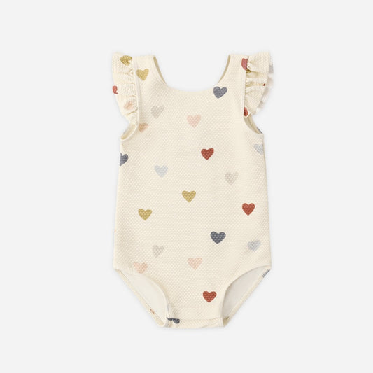 Baby swimsuit with heart pattern on a white background