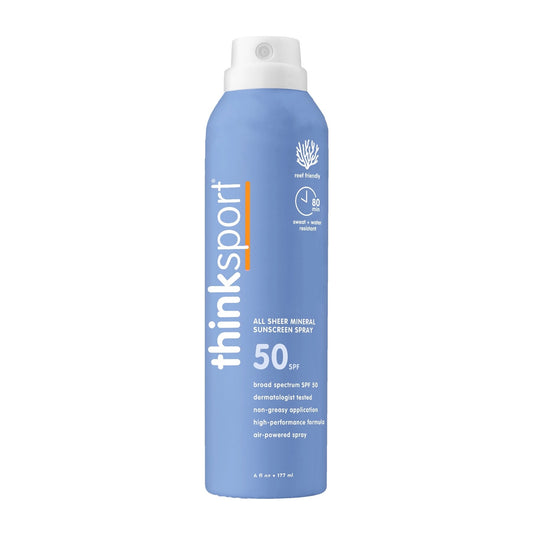 Blue sunscreen spray bottle with white cap on a white background