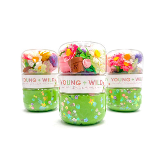Three small jars with floral designs and 'Young + Wild' branding on a white background