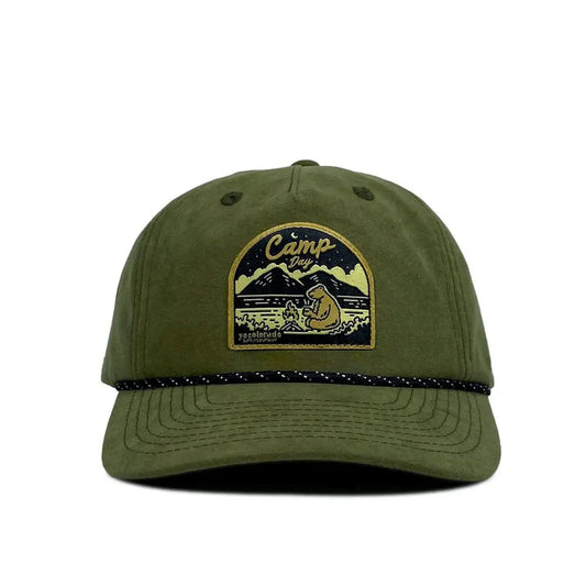 Green cap with a camping-themed patch on a white background