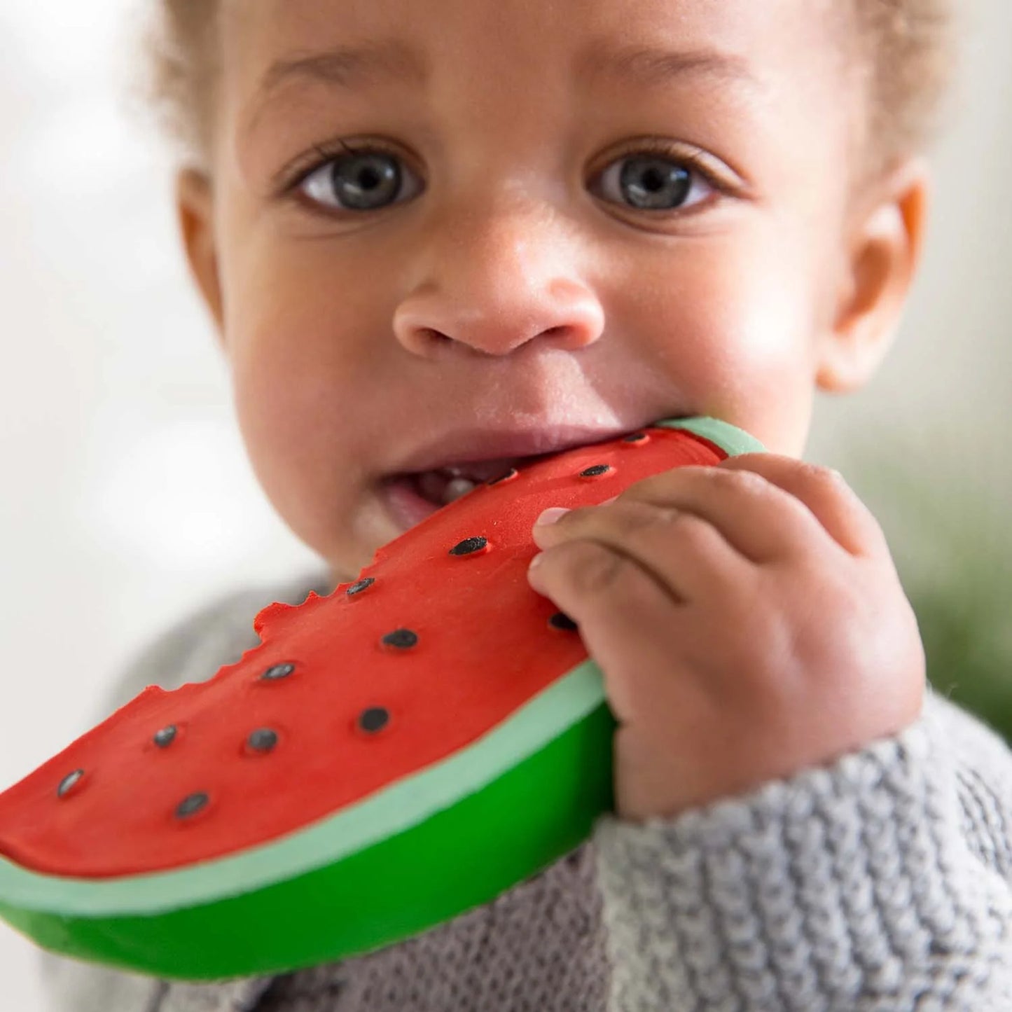 child holding watermelon teether