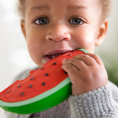 child holding watermelon teether