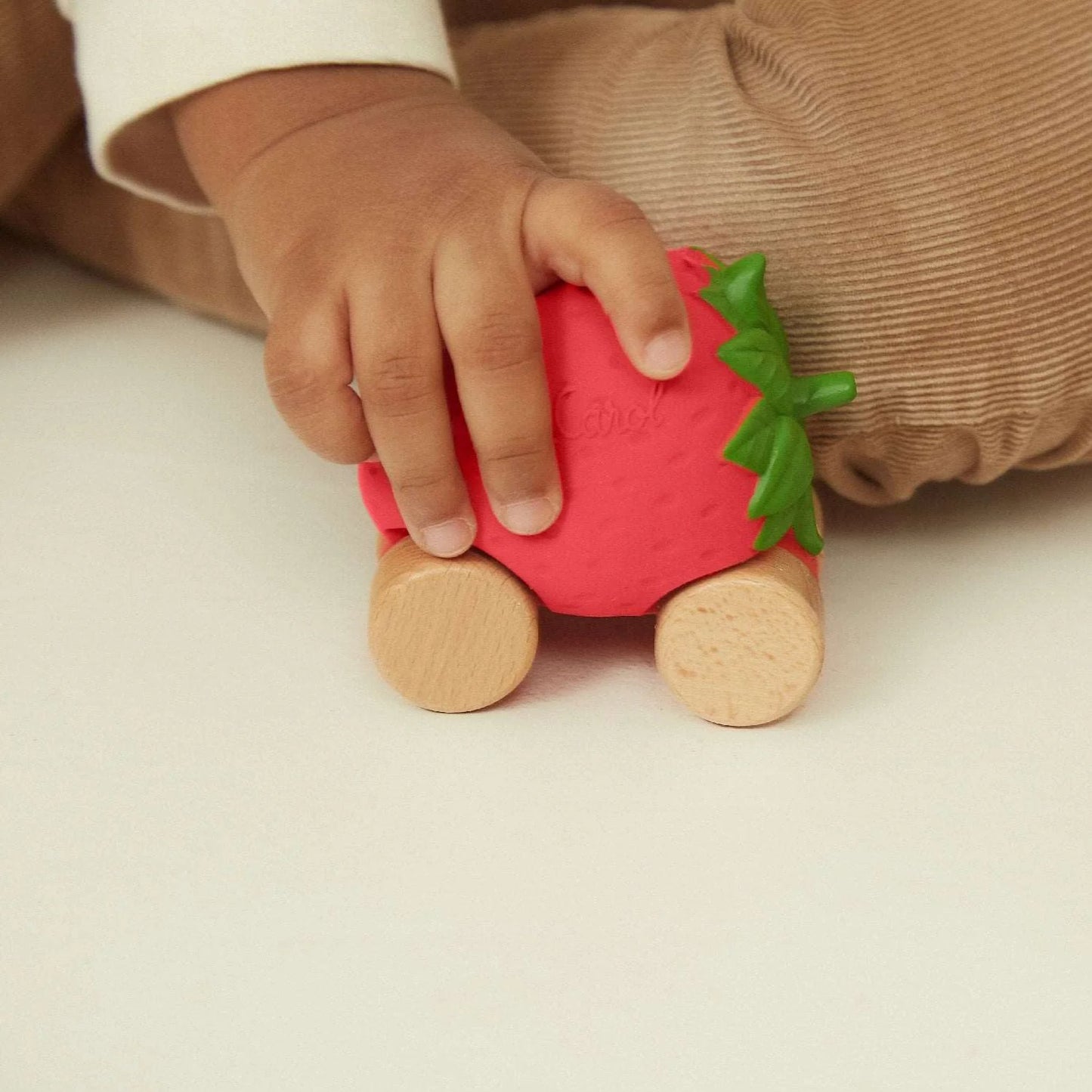 child playing with strawberry car