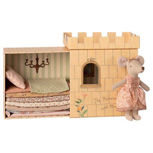 Cardboard castle toy with a mouse doll in a dress on a white background
